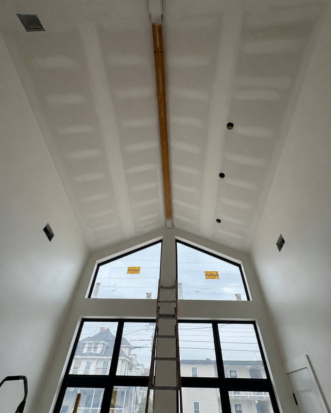 Vaulted ceiling during drywall and beam preparation